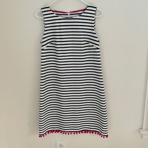 Navy and white striped shift with hot pink pompon fringe along hem